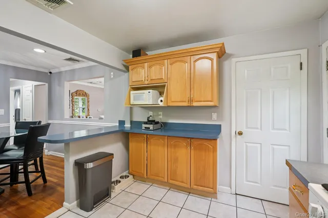 a spacious bathroom with a granite countertop sink a mirror and a bathtub
