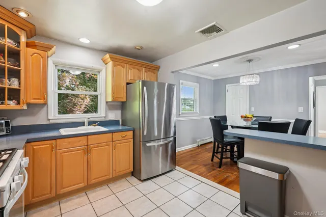 a kitchen with stainless steel appliances granite countertop a refrigerator and a sink
