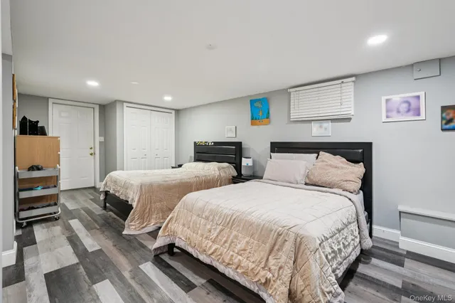 a bedroom with two beds and a closet