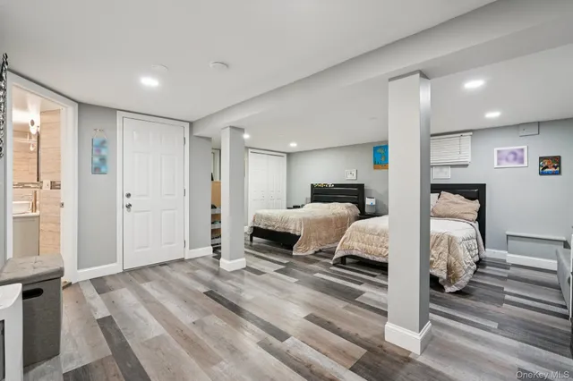 a bedroom with a bed and a large mirror