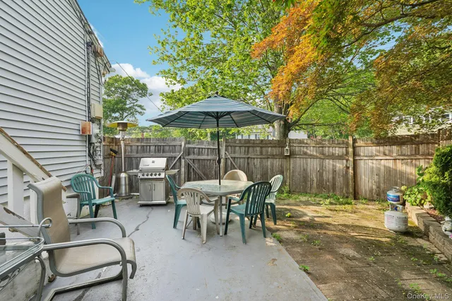 a view of a tables and chairs under an umbrella