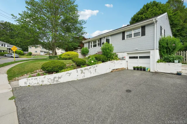 a view of a house with a yard and garage