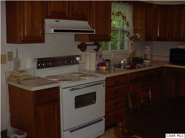 781 Poplar Spring Road Scottsville, VA 24590 - Photo 3 of 12 a kitchen with a sink stove and cabinets