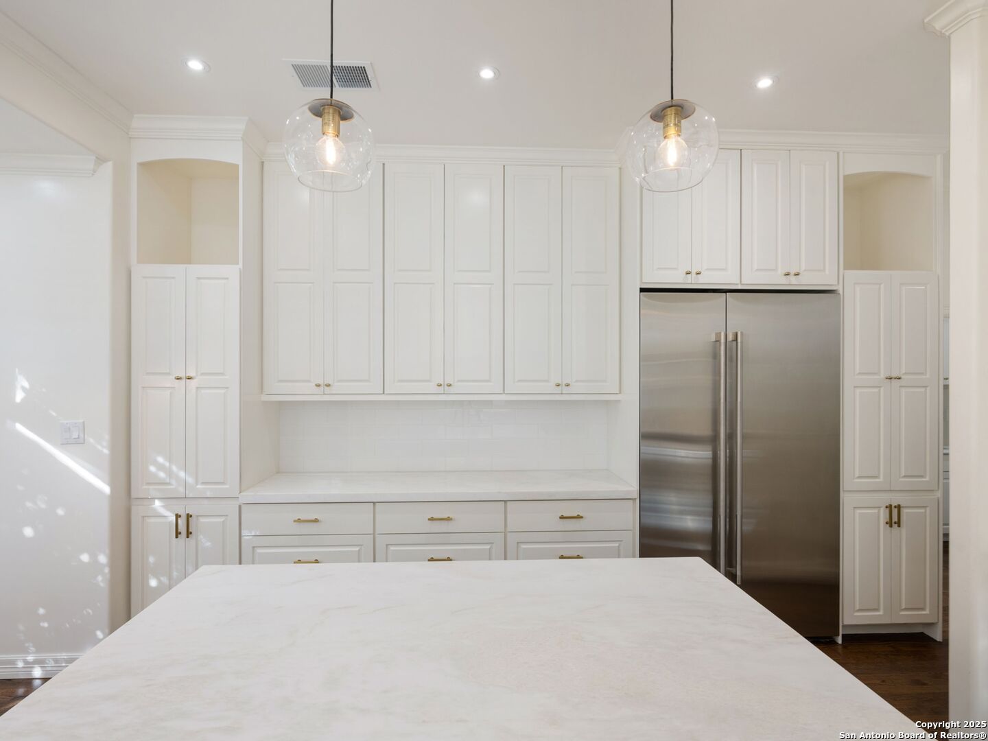 160 Burr Road San Antonio, TX 78209 - Photo 24 of 60 a large white kitchen with kitchen island white cabinets and refrigerator