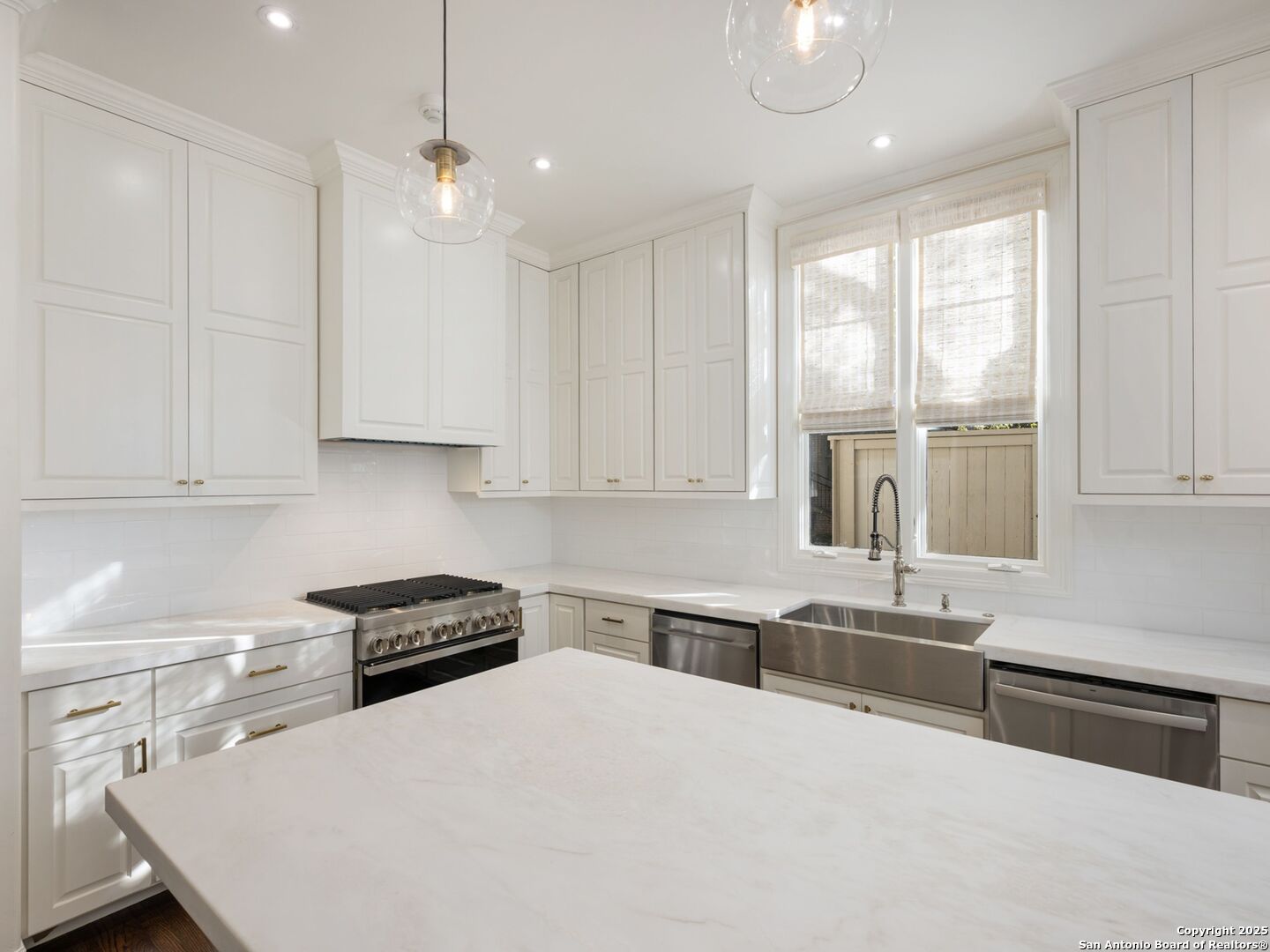 160 Burr Road San Antonio, TX 78209 - Photo 25 of 60 a kitchen with stainless steel appliances granite countertop a stove a sink and white cabinets
