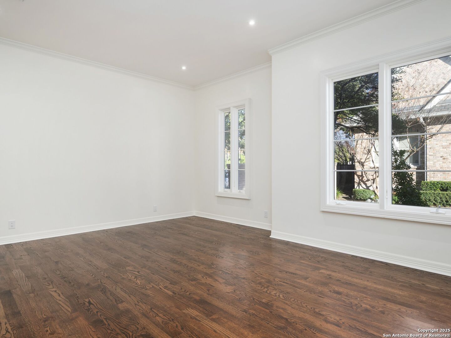 160 Burr Road San Antonio, TX 78209 - Photo 30 of 60 an empty room with wooden floor and windows