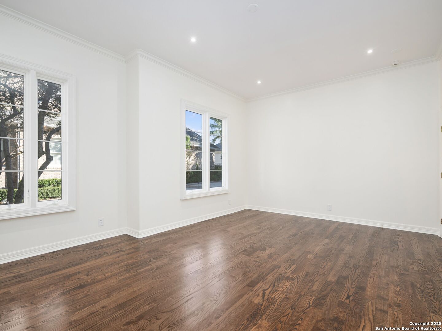 160 Burr Road San Antonio, TX 78209 - Photo 31 of 60 an empty room with wooden floor and windows