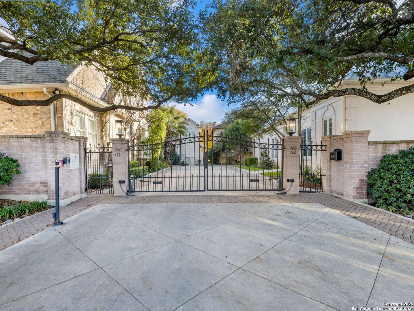 160 Burr Road San Antonio, TX 78209 - Photo 57 of 60 a view of a white house with a large tree and wooden fence