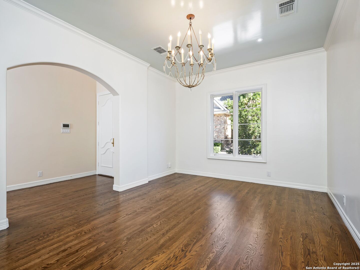 160 Burr Road San Antonio, TX 78209 - Photo 8 of 60 a view of an empty room with wooden floor and a window