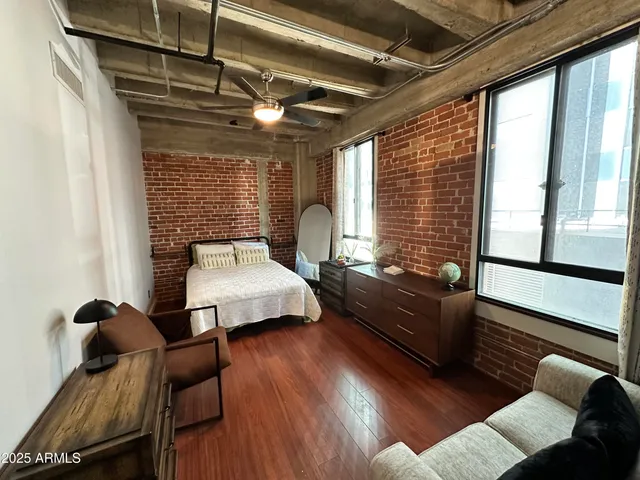 a bedroom with furniture and wooden floor