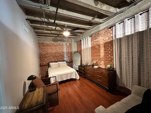 a front view of a building with swimming pool and outdoor seating