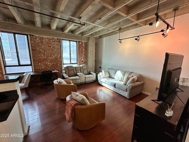 a kitchen with stainless steel appliances granite countertop a refrigerator a stove and a wooden floors