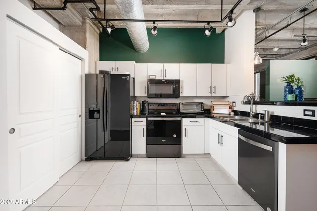 a view of a kitchen with furniture and wooden floor