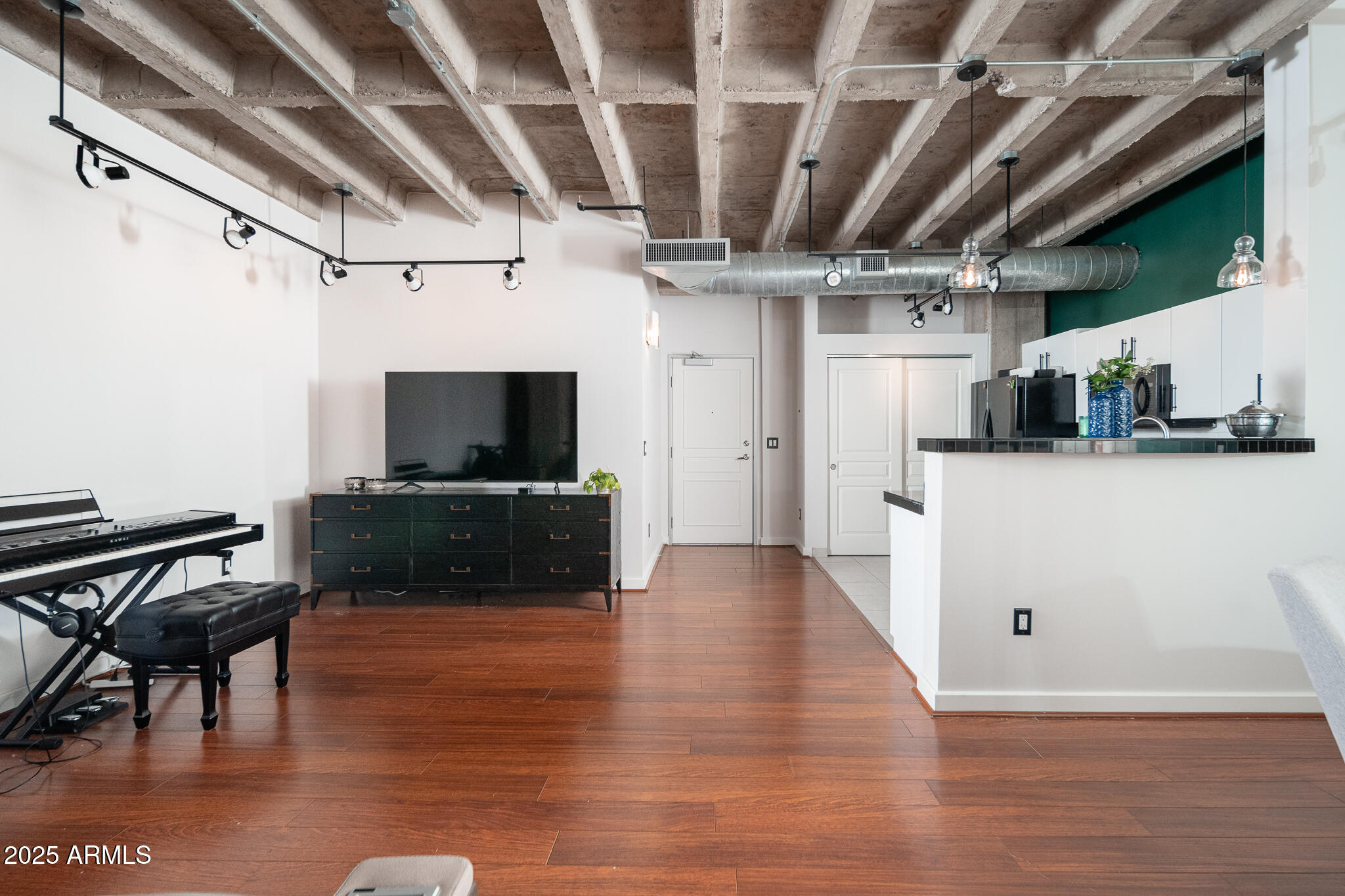 114 West Adams Street, Unit 402 Phoenix, AZ 85003 - Photo 7 of 35 a view of a kitchen with furniture and wooden floor