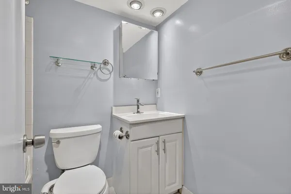 a white toilet sitting next to a bathroom sink