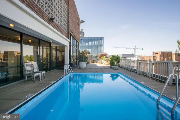 a swimming pool with outdoor seating and yard