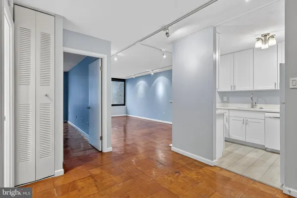 a view of a hallway to closet and utility room
