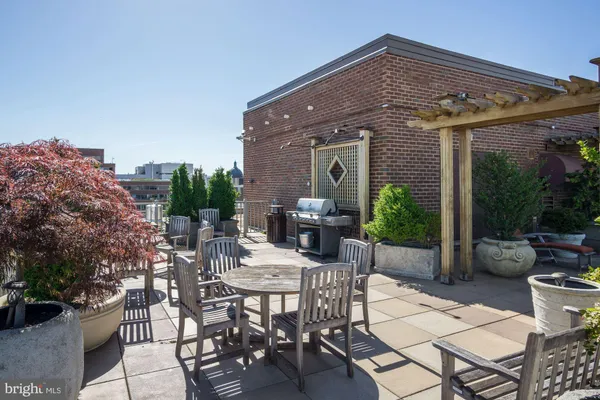 a view of a patio with a table and chairs and potted plants