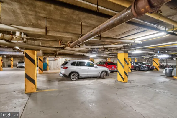 a view of parking garage with cars parked