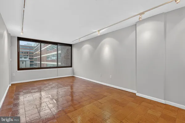 a view of an empty room with a window and closet