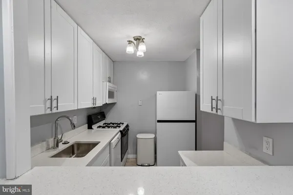a kitchen with stainless steel appliances a refrigerator sink and cabinets
