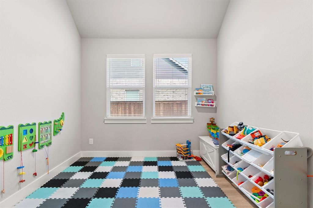 5823 Heatherwood Loop Sachse, TX 75048 - Photo 13 of 40 a room with toys and baby crib
