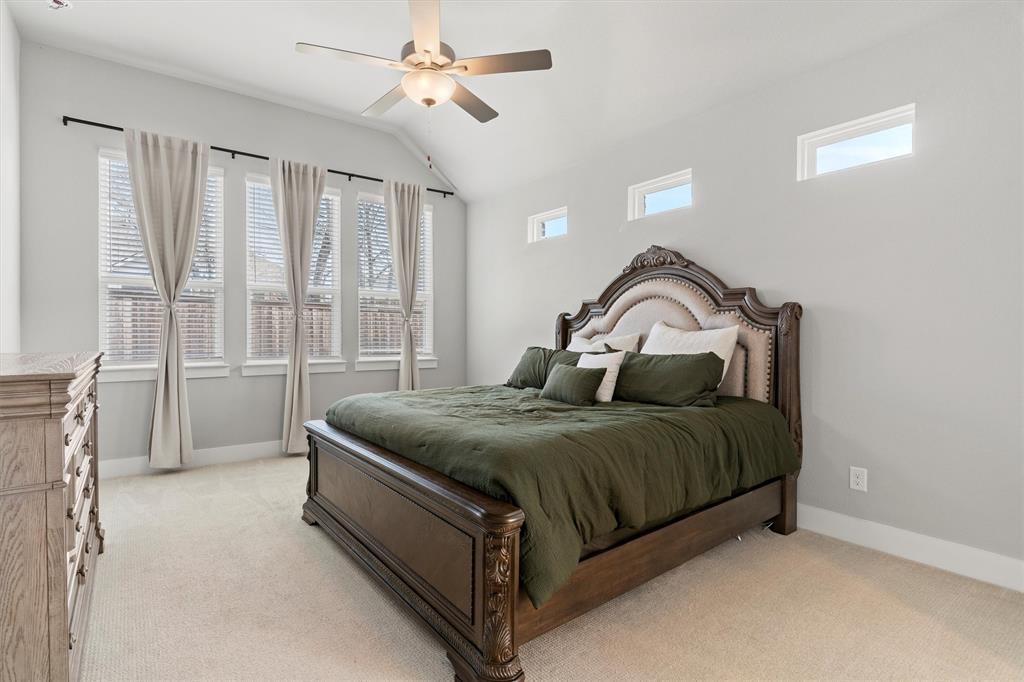 5823 Heatherwood Loop Sachse, TX 75048 - Photo 19 of 40 a bed sitting in a spacious bedroom next to a window