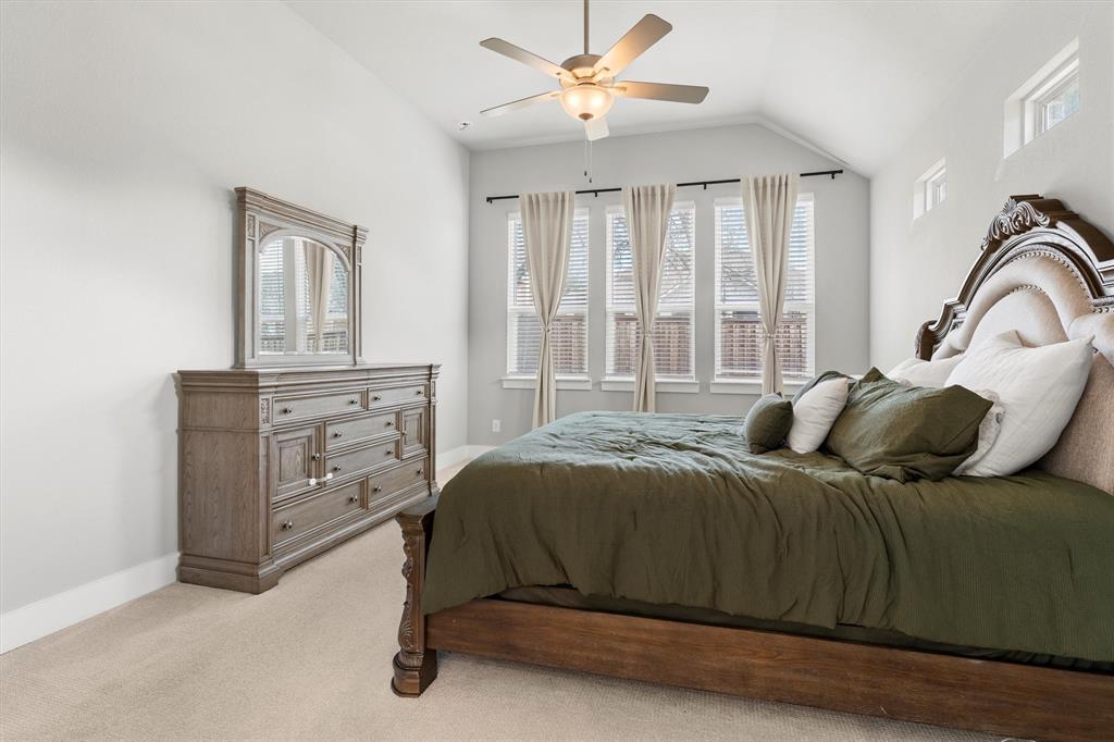 5823 Heatherwood Loop Sachse, TX 75048 - Photo 21 of 40 a bedroom with a bed and a dresser