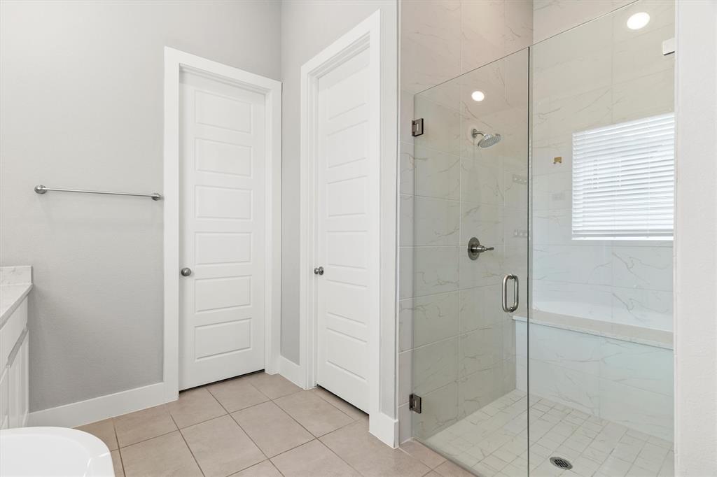 5823 Heatherwood Loop Sachse, TX 75048 - Photo 25 of 40 a bathroom with a shower and toilet