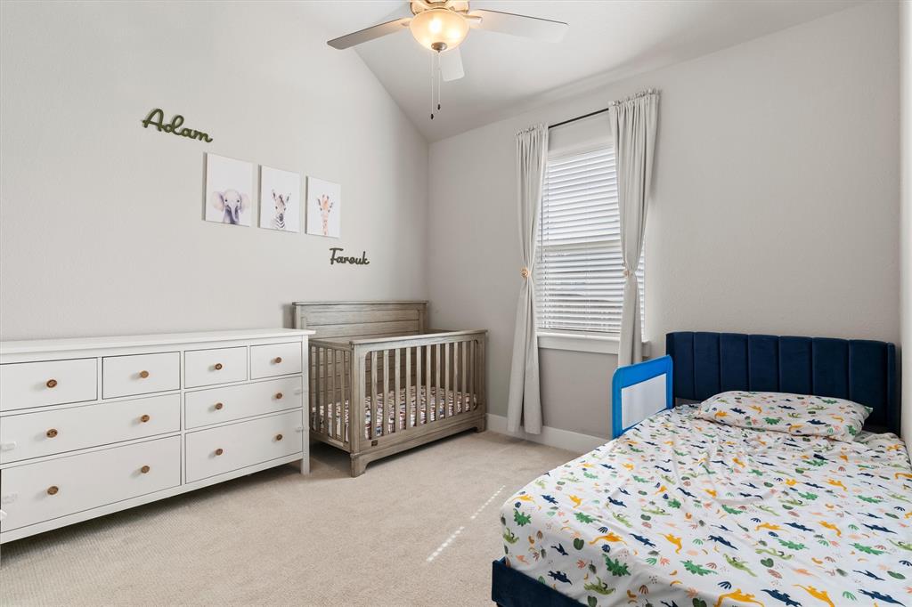 5823 Heatherwood Loop Sachse, TX 75048 - Photo 26 of 40 a bedroom with a bed a dresser and a window