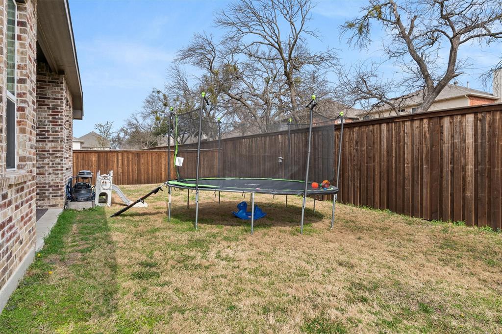 5823 Heatherwood Loop Sachse, TX 75048 - Photo 33 of 40 a view of backyard with a small swimming pool