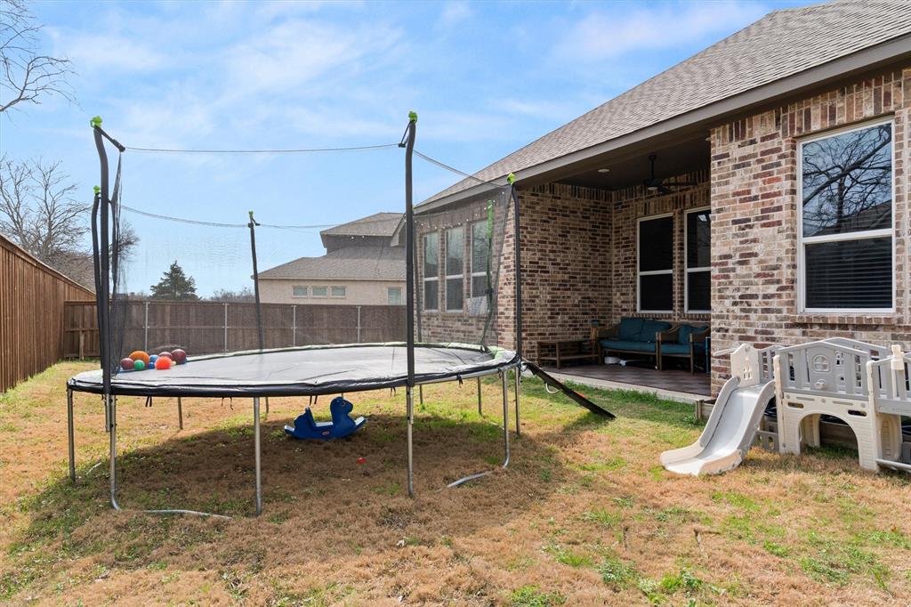 5823 Heatherwood Loop Sachse, TX 75048 - Photo 36 of 40 a view of a house with a backyard