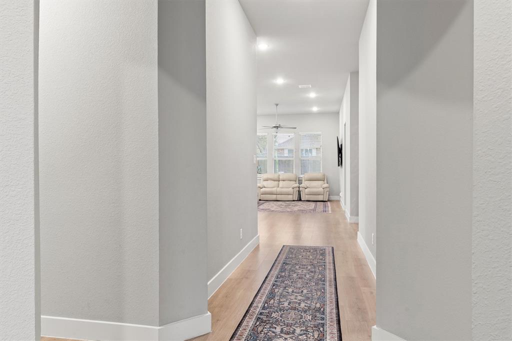 5823 Heatherwood Loop Sachse, TX 75048 - Photo 5 of 40 a view of a hallway with wooden floor