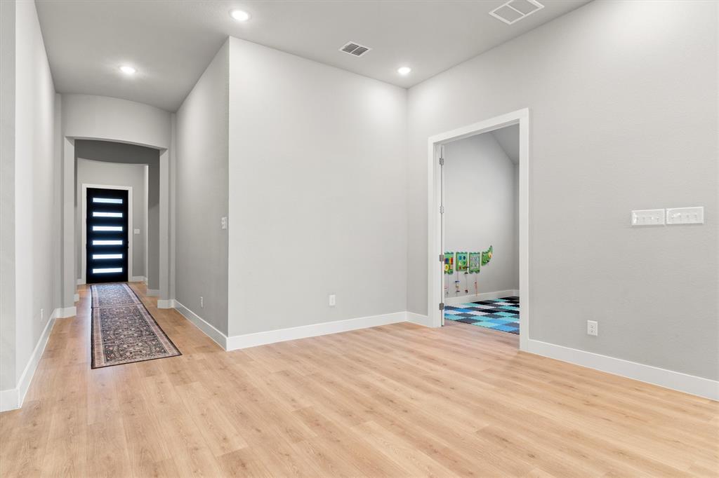 5823 Heatherwood Loop Sachse, TX 75048 - Photo 7 of 40 wooden floor in an empty room with a workspace