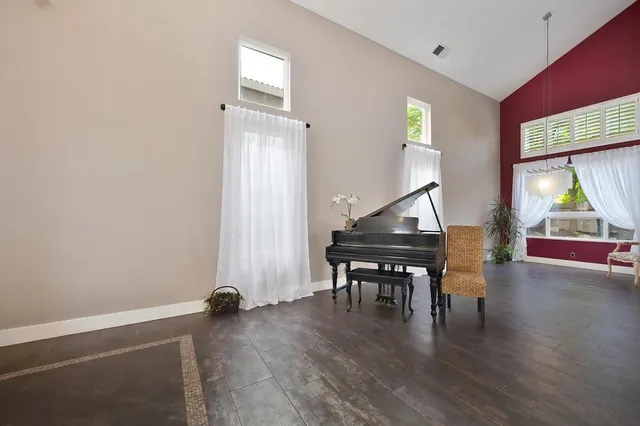 a view of a kitchen with kitchen island a large window cabinets and stainless steel appliances