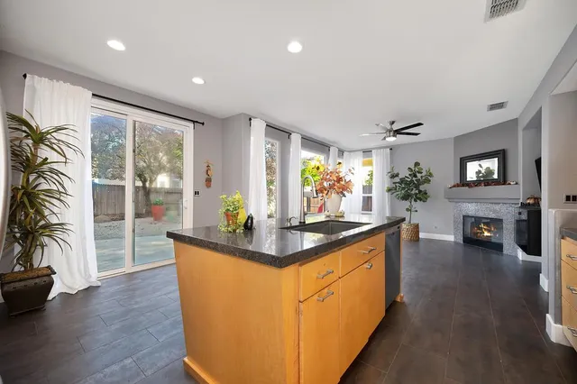 a living room with wooden floor and a fireplace