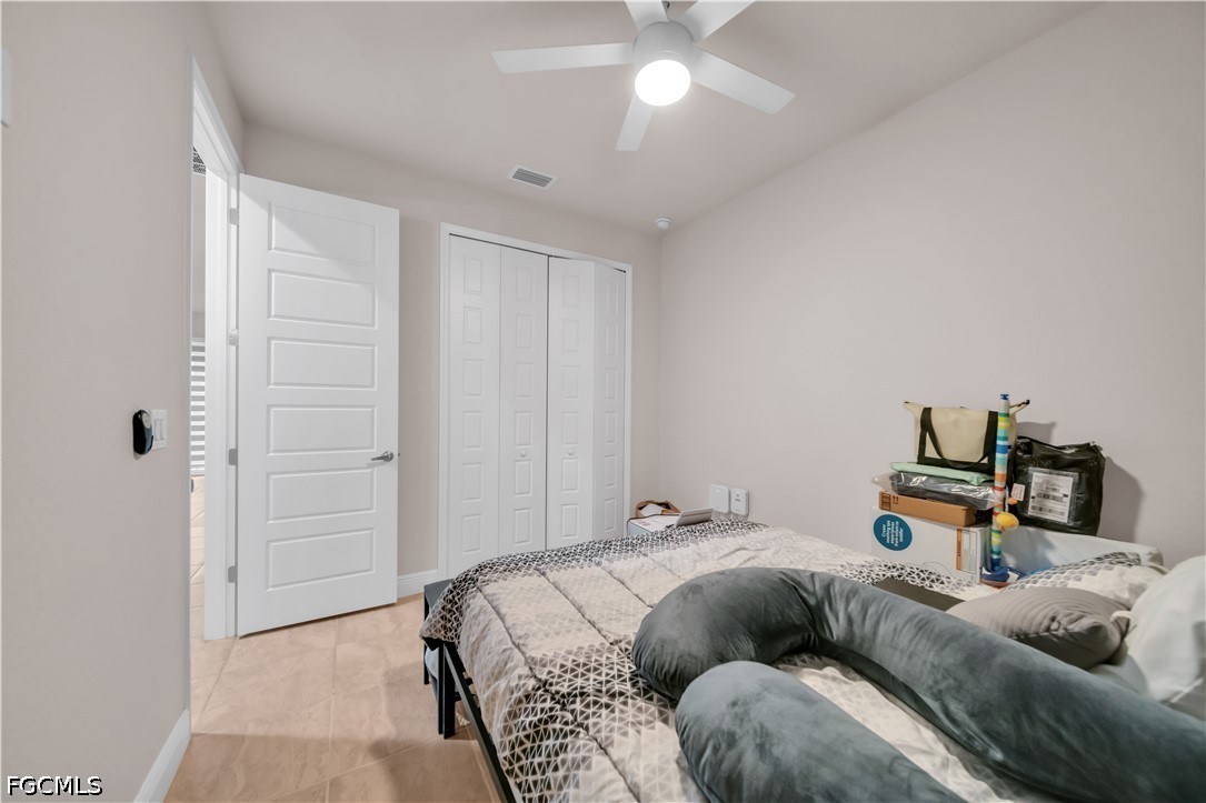 384 Neighborly Road LaBelle, FL 33935 - Photo 29 of 45 a bedroom with a bed and a chandelier