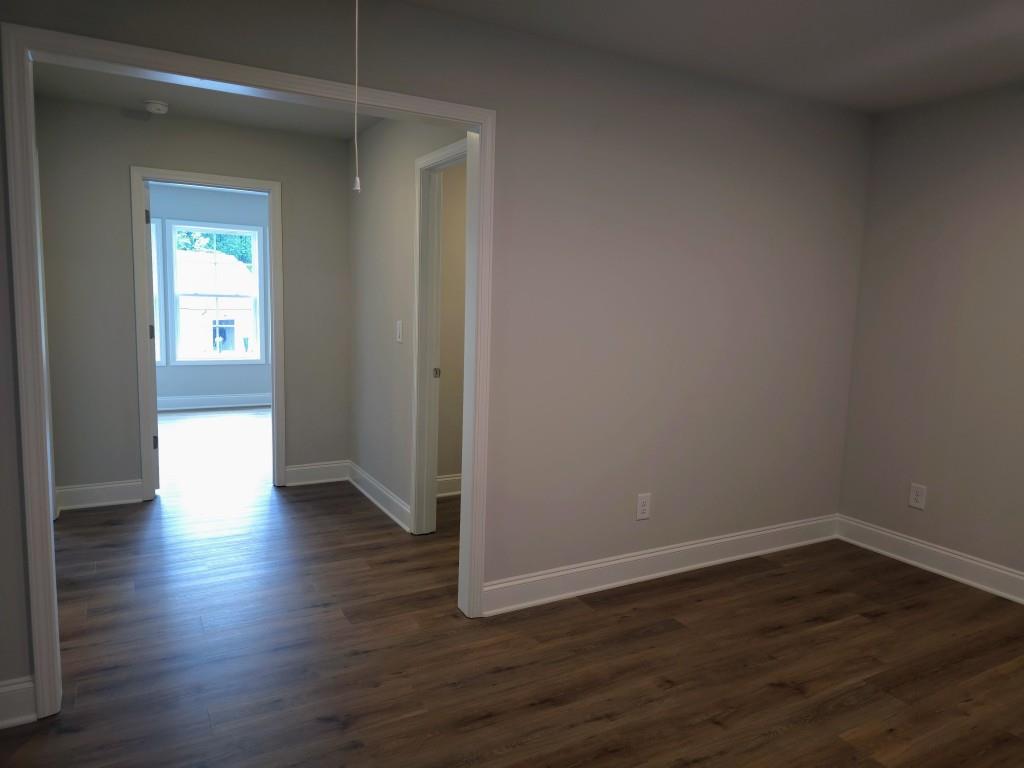 4240 Cavalier Way Duluth, GA 30097 - Photo 17 of 46 a view of an empty room with wooden floor and a window