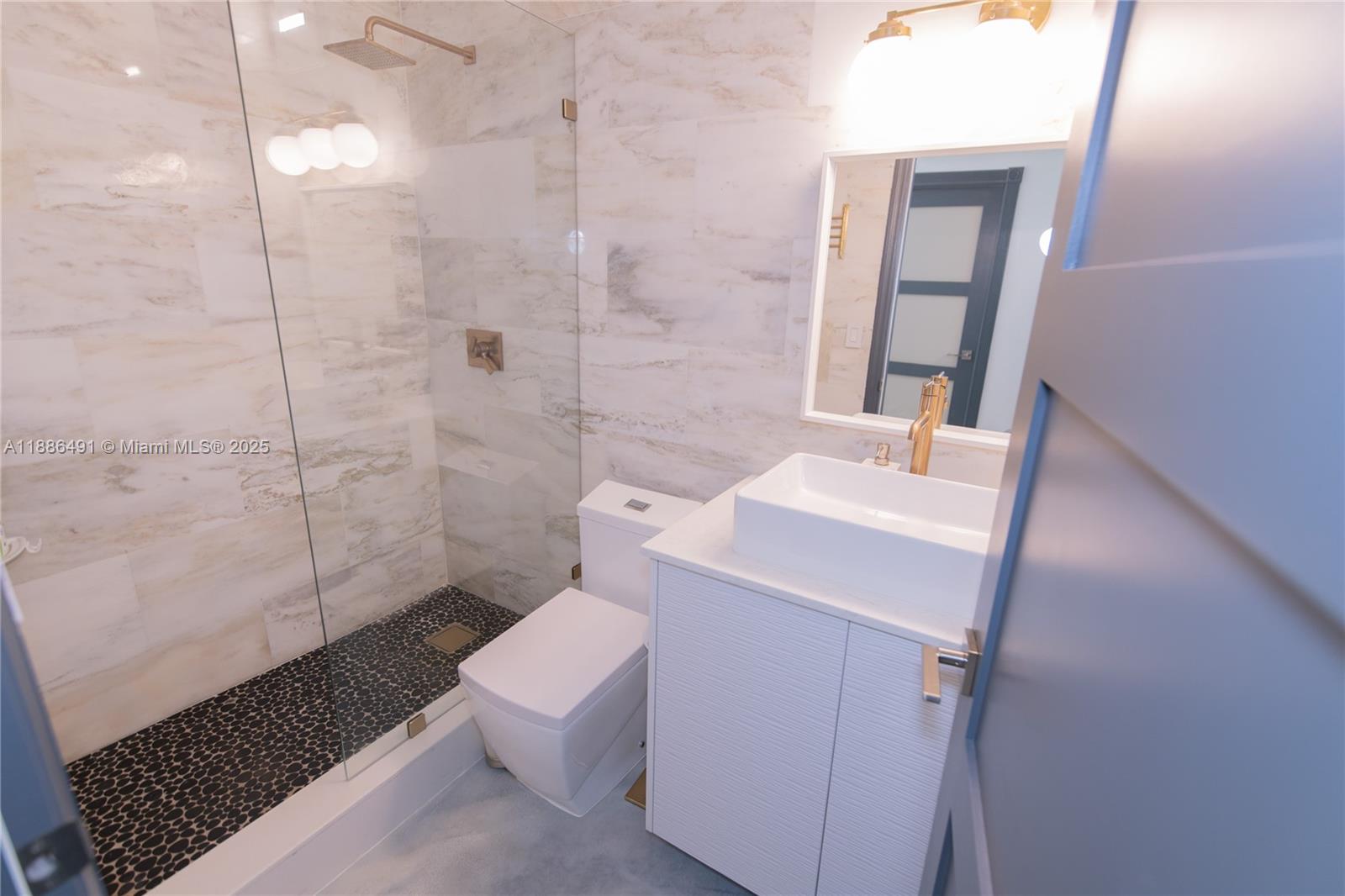8694 Vía Reale, Unit 3 Boca Raton, FL 33496 - Photo 11 of 15 a bathroom with a sink a toilet and shower