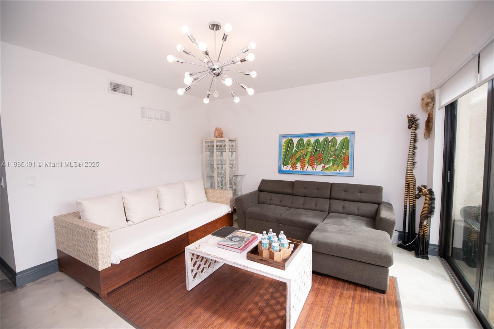 8694 Vía Reale, Unit 3 Boca Raton, FL 33496 - Photo 12 of 15 a living room with furniture and a wooden floor