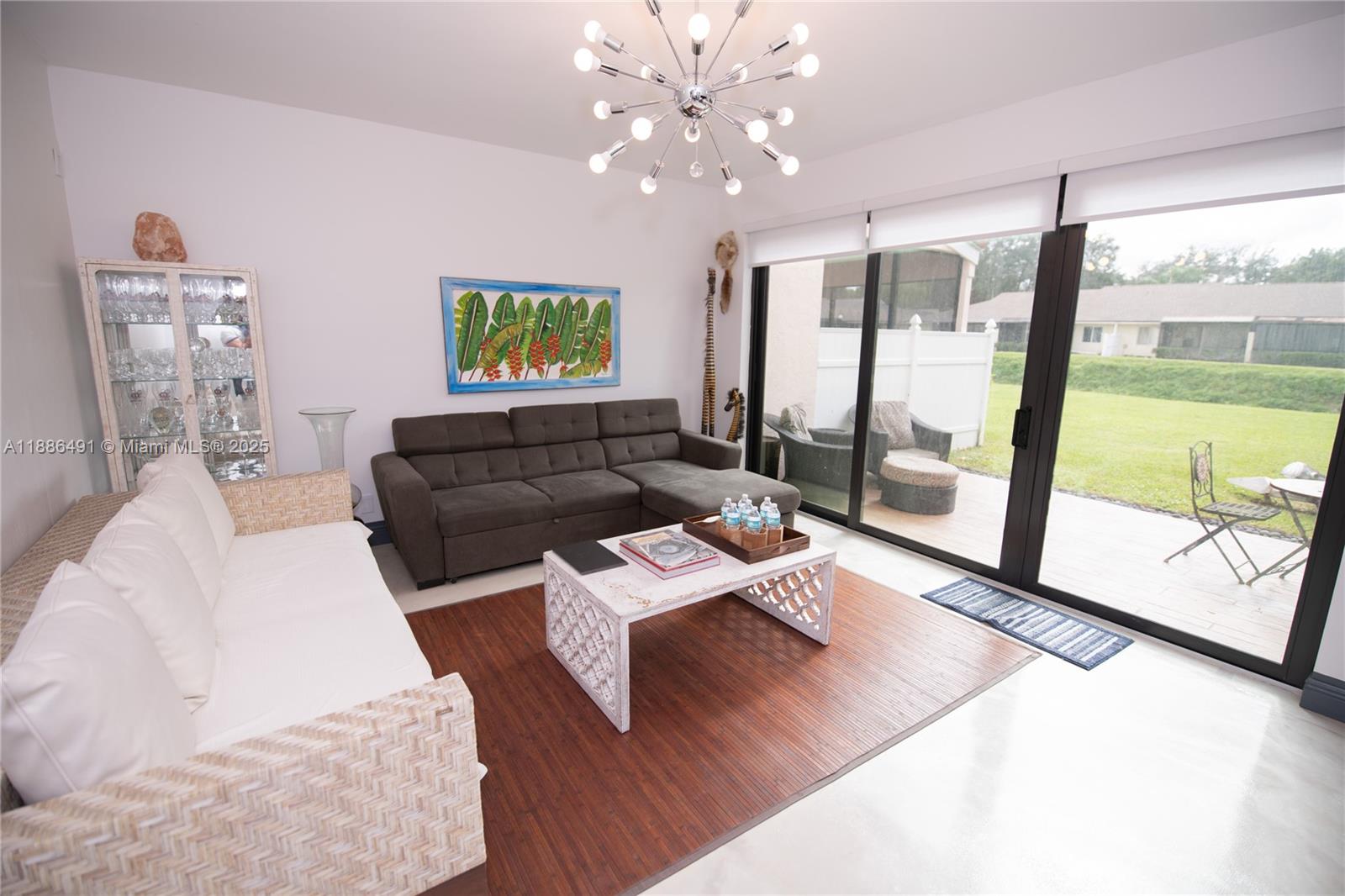 8694 Vía Reale, Unit 3 Boca Raton, FL 33496 - Photo 13 of 15 a living room with furniture and a floor to ceiling window