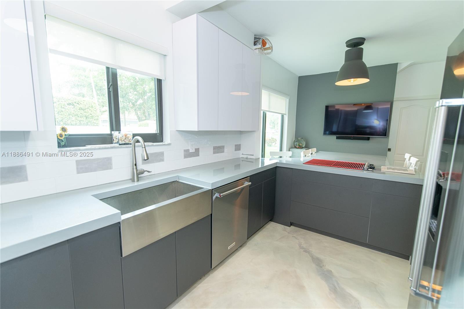 8694 Vía Reale, Unit 3 Boca Raton, FL 33496 - Photo 6 of 15 a kitchen with stainless steel appliances a sink stove and refrigerator
