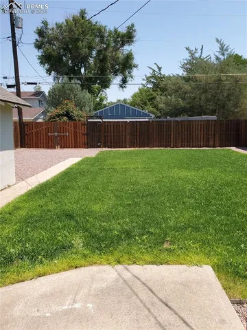 a view of a backyard with a small cabin and a chair