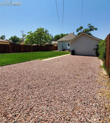 a house with green field in front of it