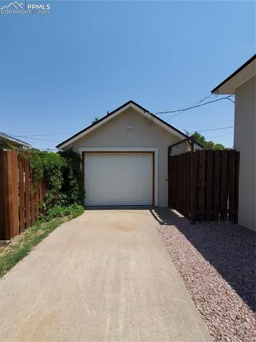 a front view of house with wooden fence