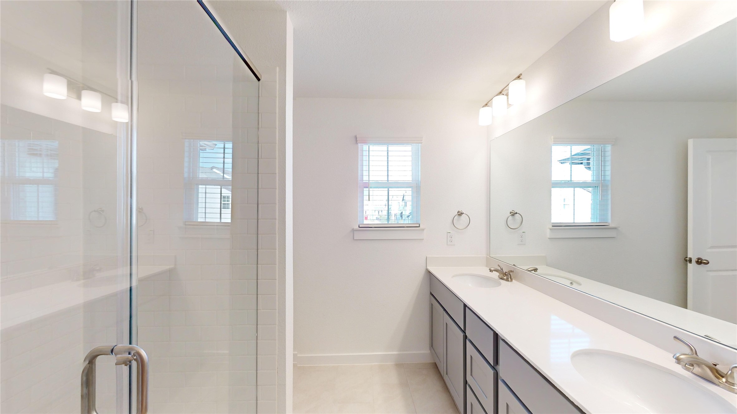 4118 Ruth Alley Grand Prairie, TX 75052 - Photo 29 of 42 a bathroom with a double vanity sink a mirror and a shower
