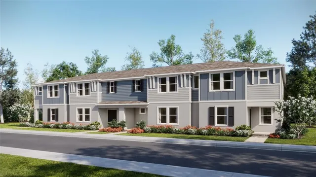 front view of a brick house with a yard