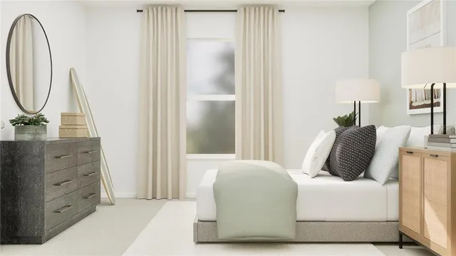 a bedroom with a bed a mirror and lamp