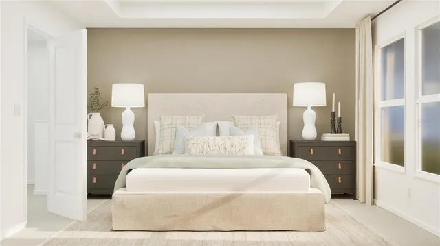 a large bed sitting in a bedroom next to a lamp