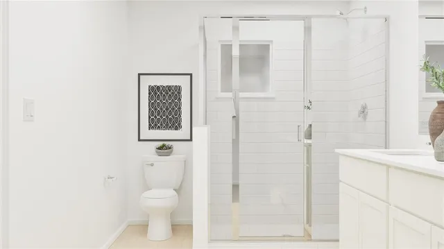 a bathroom with a toilet a sink and shower